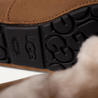 Close-up of a brown UGG shoe sole with brand logo.